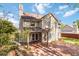 This backyard features a covered porch and brick patio, perfect for entertaining at 2470 Suwanee Lakes Trl, Suwanee, GA 30024