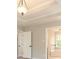 Spacious bedroom featuring tray ceiling and access to the bathroom at 2470 Suwanee Lakes Trl, Suwanee, GA 30024