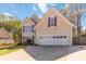 Inviting home with well-manicured lawn, spacious driveway, and appealing architectural details at 2470 Suwanee Lakes Trl, Suwanee, GA 30024