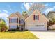 Charming home with red shutters and well-maintained lawn, showcasing curb appeal and a welcoming facade at 2470 Suwanee Lakes Trl, Suwanee, GA 30024