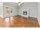 Cozy living room with hardwood floors, fireplace, and French doors, providing a comfortable and stylish gathering space at 2470 Suwanee Lakes Trl, Suwanee, GA 30024