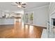 Spacious living area with hardwood floors, fireplace, and seamless access to the kitchen, ideal for entertaining at 2470 Suwanee Lakes Trl, Suwanee, GA 30024