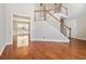 Open-concept living area with hardwood floors, staircase, and neutral walls, ideal for modern living at 2470 Suwanee Lakes Trl, Suwanee, GA 30024
