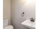 Cozy powder room featuring a pedestal sink and classic fixtures at 2470 Suwanee Lakes Trl, Suwanee, GA 30024