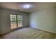 This bedroom features neutral carpet, a window with blinds, and natural light at 260 Eastwood Forest, Covington, GA 30014
