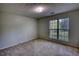 This bedroom features neutral carpet, a window with blinds, and textured ceilings at 260 Eastwood Forest, Covington, GA 30014