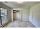 This bedroom features neutral carpet, an open closet, and a window with blinds at 260 Eastwood Forest, Covington, GA 30014
