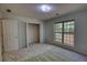 This bedroom features neutral carpet, a window with blinds, closet, and natural light at 260 Eastwood Forest, Covington, GA 30014