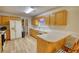 Functional kitchen with light wood cabinets, laminate countertop and open access to dining and living areas at 260 Eastwood Forest, Covington, GA 30014