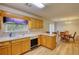 A kitchen area with wooden cabinets, appliances, a sink, and an adjacent dining space at 260 Eastwood Forest, Covington, GA 30014