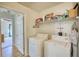 Laundry room featuring a washer, dryer, and open shelving for storage at 260 Eastwood Forest, Covington, GA 30014