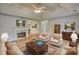 Open living room with hardwood floors, a fireplace and tray ceilings at 260 Eastwood Forest, Covington, GA 30014
