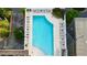Aerial view of a sparkling swimming pool with surrounding lounge chairs, greenery, and urban landscape at 3324 Peachtree Ne Rd # 1518, Atlanta, GA 30326