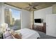 Bright and airy bedroom with a cityscape view from a large window, a TV, and a modern dresser set at 3324 Peachtree Ne Rd # 1518, Atlanta, GA 30326