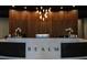 Modern reception area features a sleek desk with the word 'REALM', accented by elegant decor and lighting at 3324 Peachtree Ne Rd # 1518, Atlanta, GA 30326