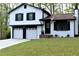 Beautifully renovated home with fresh paint, a manicured lawn, and a two-car garage at 3867 Cherie Glen Rd, Snellville, GA 30039
