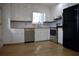 The open kitchen features stainless steel appliances, white cabinets, and wood floors at 3867 Cherie Glen Rd, Snellville, GA 30039