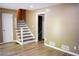Spacious living room with wood floors and staircase entrance at 3867 Cherie Glen Rd, Snellville, GA 30039