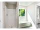 Bathroom showcasing a shower and a window with a built-in bench seat at 960 Revere Way, Hampton, GA 30228
