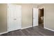 Bedroom with double door closet, neutral paint and flooring and view into the home at 960 Revere Way, Hampton, GA 30228
