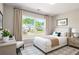 Cozy bedroom featuring a large window with neighborhood views and neutral decor at 960 Revere Way, Hampton, GA 30228