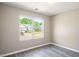 Bedroom with a large window showcasing an outdoor view and neutral walls and floors at 960 Revere Way, Hampton, GA 30228