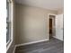 Bedroom featuring neutral walls and baseboards, gray flooring, and a view of the neighborhood at 960 Revere Way, Hampton, GA 30228