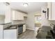 Modern kitchen featuring stainless steel appliances, granite countertops, and neutral-colored cabinets at 960 Revere Way, Hampton, GA 30228