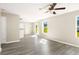 Open-concept living area with modern flooring, neutral paint, ceiling fan, and lots of natural light at 960 Revere Way, Hampton, GA 30228