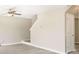 Spacious living room featuring hardwood floors, neutral paint, ceiling fan, and stairway to the second floor at 960 Revere Way, Hampton, GA 30228
