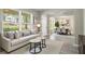 Bright living room featuring large windows, neutral tones, and an open layout to the dining area at 960 Revere Way, Hampton, GA 30228