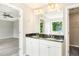 Bathroom features a double sink vanity with a granite countertop and large mirror at 960 Revere Way, Hampton, GA 30228