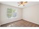 Cozy bedroom with carpet, a ceiling fan, and a bright window at 1066 Rock Creek Ln, Norcross, GA 30093