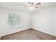 Bedroom featuring a bright window, ceiling fan, and neutral walls at 1066 Rock Creek Ln, Norcross, GA 30093