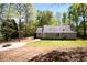 Expansive backyard features a fire pit and lush greenery, creating a serene outdoor retreat at 11268 Flat Shoals Rd, Covington, GA 30016
