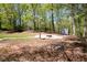 Landscaped backyard featuring a fire pit and shed, perfect for outdoor entertaining at 11268 Flat Shoals Rd, Covington, GA 30016