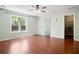 Spacious bedroom with hardwood floors, large windows, and a ceiling fan at 11268 Flat Shoals Rd, Covington, GA 30016