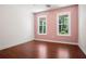 Bright bedroom with hardwood floors and multiple windows offering ample natural light at 11268 Flat Shoals Rd, Covington, GA 30016