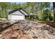 Exterior shot of home featuring a long driveway, front lawn, and attached two-car garage at 11268 Flat Shoals Rd, Covington, GA 30016