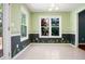 Well-lit eat-in kitchen featuring tiled floors, wainscotting, and a large window at 11268 Flat Shoals Rd, Covington, GA 30016