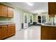 Well-lit eat-in kitchen features white tile floors, wood cabinets, and backyard access at 11268 Flat Shoals Rd, Covington, GA 30016