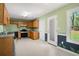 Kitchen featuring tile floors, wood cabinets, stainless steel appliances, and backyard views at 11268 Flat Shoals Rd, Covington, GA 30016