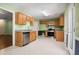 Bright kitchen featuring tile floors, wood cabinets, and stainless steel appliances at 11268 Flat Shoals Rd, Covington, GA 30016