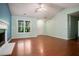 Well-lit living room featuring hardwood floors, neutral paint, and an elegant fireplace at 11268 Flat Shoals Rd, Covington, GA 30016