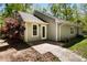 The back of the home features neutral vinyl siding, a small concrete patio, and a well-manicured, landscaped lot at 11268 Flat Shoals Rd, Covington, GA 30016