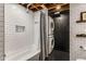 Bright bathroom with subway tile walls, a tub, and modern fixtures, accompanied by a convenient stacked washer and dryer at 1570 Dekalb Ne Ave # F, Atlanta, GA 30307