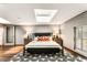 Bright bedroom featuring a decorative rug, modern decor, and a stylish black bed frame at 1570 Dekalb Ne Ave # F, Atlanta, GA 30307