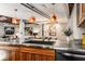 Close up of modern kitchen featuring wood cabinets, steel countertop, industrial lighting, and artwork at 1570 Dekalb Ne Ave # F, Atlanta, GA 30307