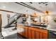 Modern kitchen features wood cabinets, steel countertop, industrial lighting, and staircase access at 1570 Dekalb Ne Ave # F, Atlanta, GA 30307