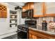 Close-up of a kitchen featuring modern appliances and custom wood cabinetry at 1570 Dekalb Ne Ave # F, Atlanta, GA 30307